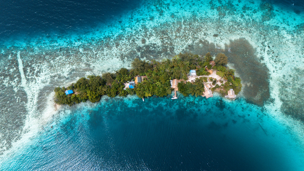 Aerial view of a lush tropical island surrounded by turquoise and deep blue waters a tranquil haven in the vast ocean Solomon Islands Solomon Islands Solomon Islands. Aerial view of a lush tropical island surrounded by turquoise and deep blue waters a tranquil haven in the vast ocean Solomon Islands Solomon Islands Solomon Islands.