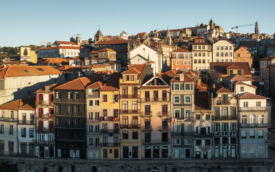 Aerial view of historic Porto featuring colorful traditional buildings with terracotta rooftops narrow streets and iconic riverside architecture in Porto Porto District Portugal.