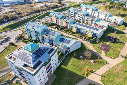 Aerial view of modern residential buildings with solar panels on rooftops and green gardens in Grugliasco Piedmont Italy. Aerial view of modern residential buildings with solar panels on rooftops and green gardens in Grugliasco Piedmont Italy.