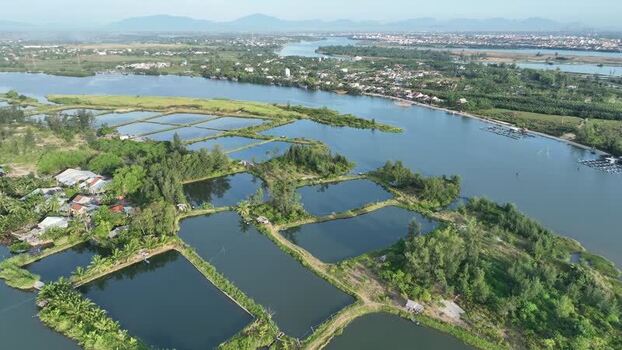 Aerial view of aquaculture ponds along the Thu Bon River Vietnam. Aerial view of aquaculture ponds along the Thu Bon River Vietnam.