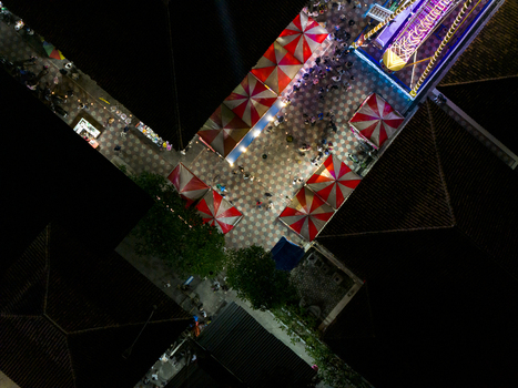 Aerial view of GOR Gelarsena Klaten Night Market with red and white striped tents crowds of people and vibrant lights at night Kecamatan Klaten Utara Jawa Tengah Indonesia. Aerial view of GOR Gelarsena Klaten Night Market with red and white striped tents crowds of people and vibrant lights at night Kecamatan Klaten Utara Jawa Tengah Indonesia.