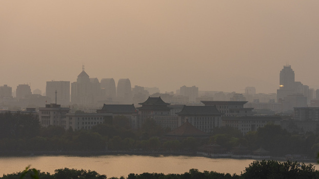 View of the historic architecture of the Forbidden City and modern skyline of Beijing under a hazy sky in Beijing Beijing China. View of the historic architecture of the Forbidden City and modern skyline of Beijing under a hazy sky in Beijing Beijing China.