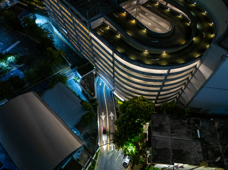 Aerial view of a multi level parking garage with a spiral ramp at night illuminated by lights Santo Domingo Distrito Nacional Dominican Republic. Aerial view of a multi level parking garage with a spiral ramp at night illuminated by lights Santo Domingo Distrito Nacional Dominican Republic.