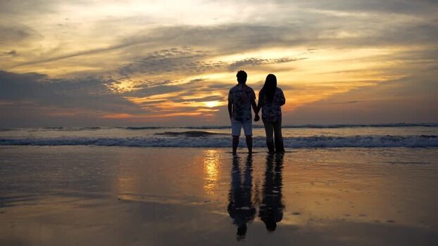 View of a couple holding hands on the beach at sunset Bangladesh. View of a couple holding hands on the beach at sunset Bangladesh.