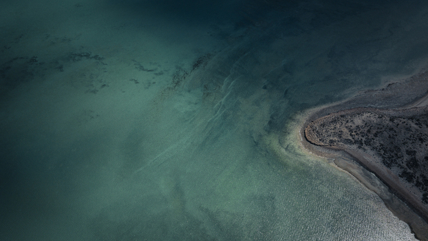 Aerial view of abstract patterns of turquoise blue water and brown sandy coastline at Useless Loop Western Australia Australia. Aerial view of abstract patterns of turquoise blue water and brown sandy coastline at Useless Loop Western Australia Australia.
