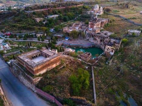 Aerial view of the historic Katas Raj Temple Complex featuring ancient stone structures a sacred pond and surrounding hilly landscape in Katas Punjab Pakistan. Aerial view of the historic Katas Raj Temple Complex featuring ancient stone structures a sacred pond and surrounding hilly landscape in Katas Punjab Pakistan.
