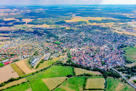 Aerial view of the town of Hochstadt featuring red roofed houses surrounded by lush green fields and dense forests Hochstadt Bavaria Germany. Aerial view of the town of Hochstadt featuring red roofed houses surrounded by lush green fields and dense forests Hochstadt Bavaria Germany.