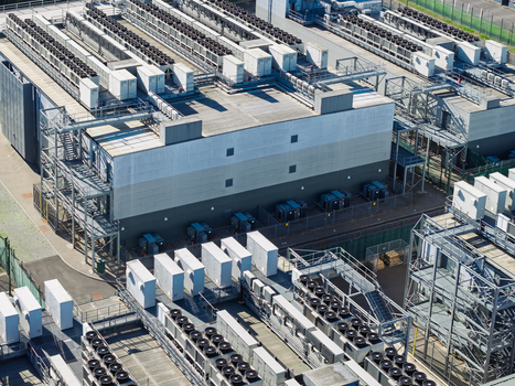 Aerial view of a data center facility featuring industrial cooling units and infrastructure in the United Kingdom.