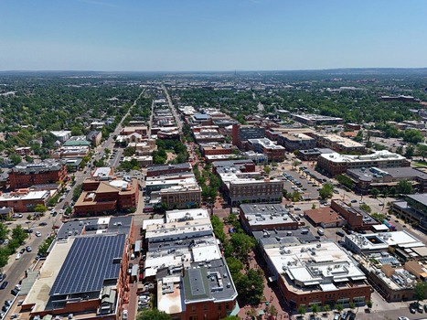 Aerial view of Pearl Street Mall in downtown Boulder featuring historic brick buildings solar panels lush trees and urban street layout in Boulder Colorado United States. Aerial view of Pearl Street Mall in downtown Boulder featuring historic brick buildings solar panels lush trees and urban street layout in Boulder Colorado United States.