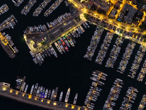 Aerial view of Port Vauban in Antibes featuring rows of yachts docked in the marina illuminated by harbor lights at night in Antibes Provence Alpes Cote d Azur France. Aerial view of Port Vauban in Antibes featuring rows of yachts docked in the marina illuminated by harbor lights at night in Antibes Provence Alpes Cote d Azur France.