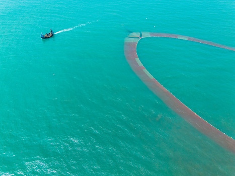 Cox s Bazar Bangladesh 10 March 2026 Aerial view of a fishing boat cutting a path through the serene turquoise waters leaving a trail of gentle ripples in its wake.