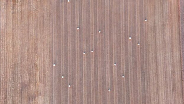 Aerial view of hay bales in a harvested field in Geneva Switzerland.