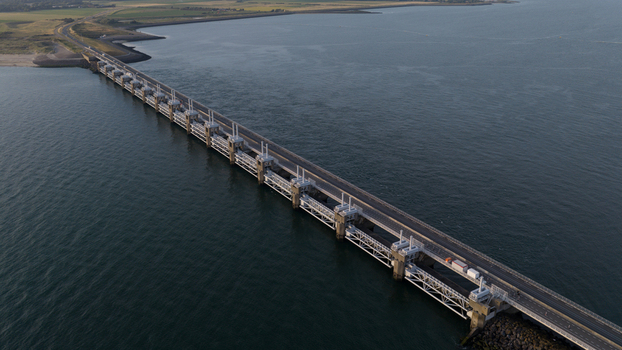 Aerial view of the Eastern Scheldt Storm Surge Barrier spanning the water showcasing its massive concrete piers and roadway in Vrouwenpolder Zeeland Netherlands. Aerial view of the Eastern Scheldt Storm Surge Barrier spanning the water showcasing its massive concrete piers and roadway in Vrouwenpolder Zeeland Netherlands.