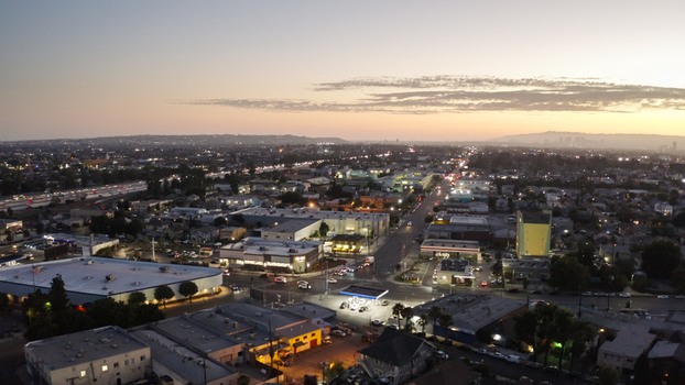 Aerial view of the urban landscape at dusk with illuminated streets traffic and commercial buildings in Los Angeles California United States. Aerial view of the urban landscape at dusk with illuminated streets traffic and commercial buildings in Los Angeles California United States.
