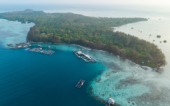 Aerial view of Menjangan Besar Island featuring shark breeding enclosures in the turquoise waters of the Karimunjawa archipelago Karimunjawa Jawa Tengah Indonesia.