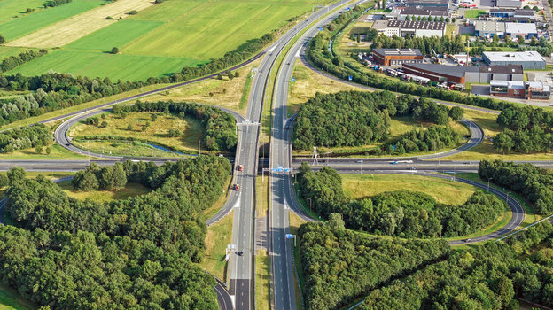 Aerial view of cloverleaf Drachten interchange surrounded by green fields and trees in Drachten Friesland Netherlands. Aerial view of cloverleaf Drachten interchange surrounded by green fields and trees in Drachten Friesland Netherlands.