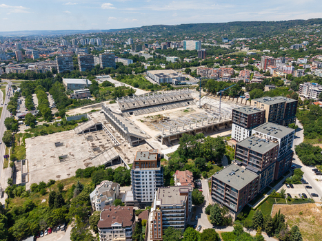 Aerial view of Stadion Varna under construction featuring concrete stadium seating construction cranes and surrounding modern apartment buildings in Varna Varna Bulgaria.