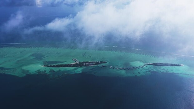 Aerial view of a tropical island resort and coral reef Maldives. Aerial view of a tropical island resort and coral reef Maldives.