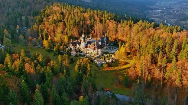 Aerial view of Peles Castle in the autumn forest Romania. Aerial view of Peles Castle in the autumn forest Romania.