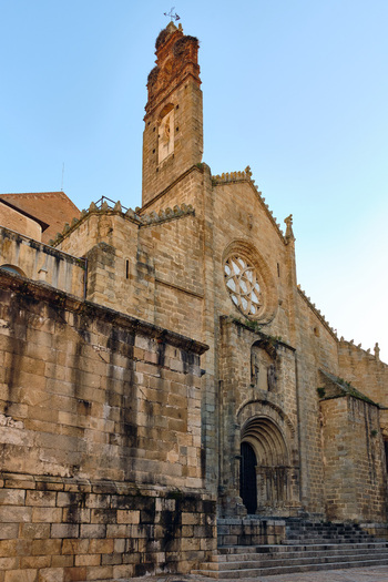 Plasencia Spain 03 December 2025 View of Catedral Nueva de Plasencia featuring its historic stone facade intricate rose window and tall bell tower under a clear blue sky. Plasencia Spain 03 December 2025 View of Catedral Nueva de Plasencia featuring its historic stone facade intricate rose window and tall bell tower under a clear blue sky.