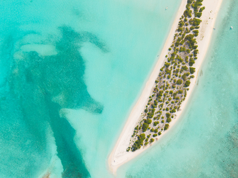 Aerial view of the serene white sand beach meeting the turquoise waters a tranquil escape in the Maldives Dhidhdhoo Thiladhunmathi Atoll Maldives.
