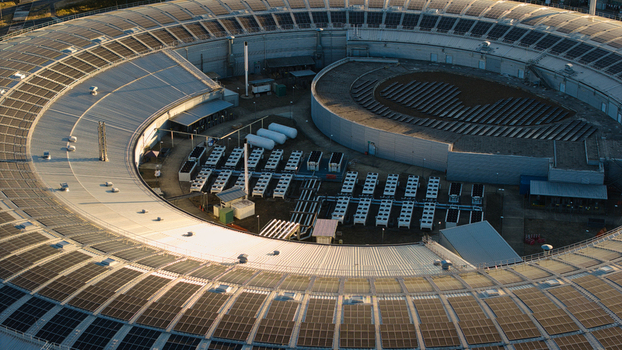 Aerial view of Diamond Light Source a circular synchrotron facility surrounded by greenery under golden hour light in Didcot United Kingdom.