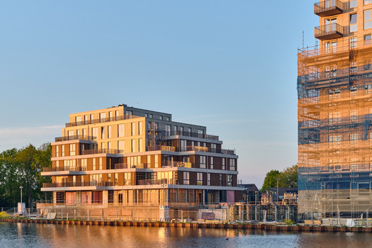 Alkmaar Netherlands 11 May 2026 View of modern residential buildings at the Alkmaar Kanaal redevelopment in the Overstad zone during golden hour with scaffolding and calm water. Alkmaar Netherlands 11 May 2026 View of modern residential buildings at the Alkmaar Kanaal redevelopment in the Overstad zone during golden hour with scaffolding and calm water.