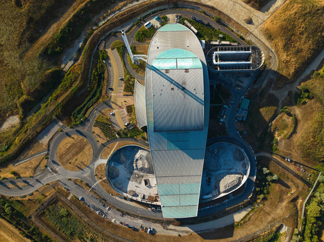 Aerial view of the Energy Recovery Facility with its distinctive oval roof surrounding access roads and industrial infrastructure in Bicester England United Kingdom.