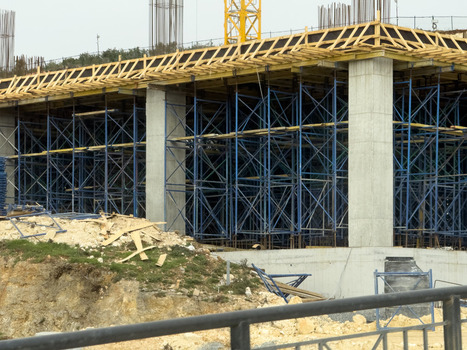 View of a construction site with concrete pillars blue metal scaffolding and wooden formwork in Beylikduzu Istanbul Turkiye. View of a construction site with concrete pillars blue metal scaffolding and wooden formwork in Beylikduzu Istanbul Turkiye.