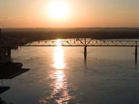 Aerial view of the George Rogers Clark Memorial Bridge spanning the Ohio River during a golden sunset with light reflecting on the water Louisville Kentucky United States. Aerial view of the George Rogers Clark Memorial Bridge spanning the Ohio River during a golden sunset with light reflecting on the water Louisville Kentucky United States.