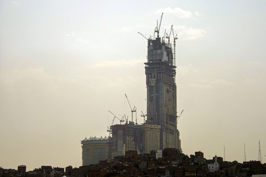 View of the Makkah Towers under construction with multiple cranes towering over the city skyline in Makkah Makkah Province Saudi Arabia. View of the Makkah Towers under construction with multiple cranes towering over the city skyline in Makkah Makkah Province Saudi Arabia.