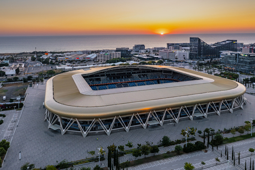 Aerial view of Sammy Ofer Stadium with its golden roof and modern architecture at sunset near the Mediterranean Sea in Haifa Haifa District Israel. Aerial view of Sammy Ofer Stadium with its golden roof and modern architecture at sunset near the Mediterranean Sea in Haifa Haifa District Israel.