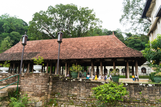 View of the historic Magul Maduwa Audience Hall with traditional wooden pillars and tiled roof at the Temple of the Sacred Tooth Relic in Kandy Central Province Sri Lanka. View of the historic Magul Maduwa Audience Hall with traditional wooden pillars and tiled roof at the Temple of the Sacred Tooth Relic in Kandy Central Province Sri Lanka.