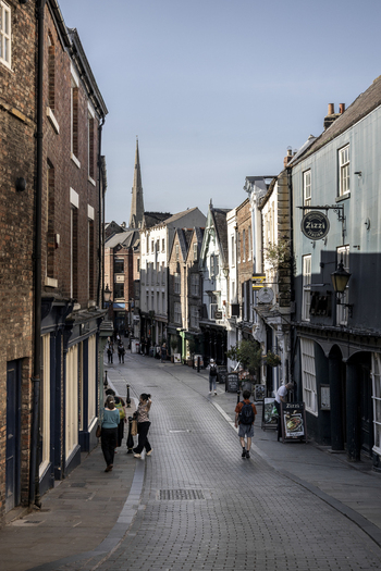 Durham United Kingdom 13 July 2026 View of a historic street in Durham with brick buildings a church spire in the distance and people walking on the cobblestone path. Durham United Kingdom 13 July 2026 View of a historic street in Durham with brick buildings a church spire in the distance and people walking on the cobblestone path.