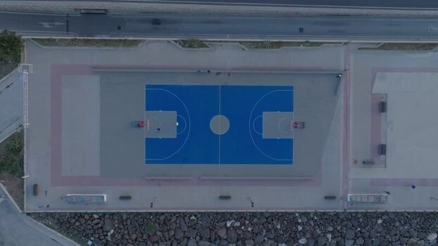 Aerial view of a blue basketball court in Syracuse Italy. Aerial view of a blue basketball court in Syracuse Italy.