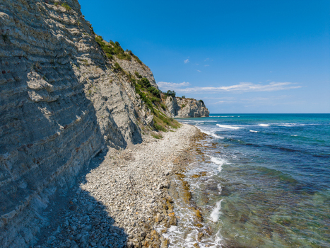 Aerial view of the White Cliffs of Byala with a rocky shoreline clear turquoise sea and blue sky in Byala Varna Bulgaria. Aerial view of the White Cliffs of Byala with a rocky shoreline clear turquoise sea and blue sky in Byala Varna Bulgaria.