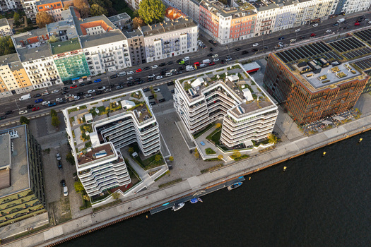 Aerial view of the Spreespeicher Promenade featuring modern U shaped residential buildings with green roofs situated along the Spree river in Berlin Berlin Germany. Aerial view of the Spreespeicher Promenade featuring modern U shaped residential buildings with green roofs situated along the Spree river in Berlin Berlin Germany.