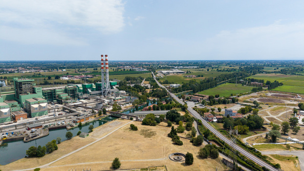 Aerial view of the TTEP Tavazzano thermal power plant and TERNA electrical substation featuring industrial cooling towers and energy infrastructure in Tavazzano con Villavesco Lombardy Italy.