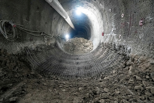 View of a large underground tunnel under construction with metal mesh reinforcement and bright lights in Istanbul Istanbul Turkiye. View of a large underground tunnel under construction with metal mesh reinforcement and bright lights in Istanbul Istanbul Turkiye.