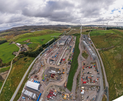 Aerial view of the Green Mountain data center construction site with industrial buildings heavy machinery and wind turbines in the rural landscape of Undheim Rogaland Norway. Aerial view of the Green Mountain data center construction site with industrial buildings heavy machinery and wind turbines in the rural landscape of Undheim Rogaland Norway.