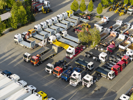 Krakow Poland 16 September 2026 Aerial view of CIEZAROWKI.PL truck dealership with rows of parked semi trucks flatbed trailers and heavy transport vehicles.