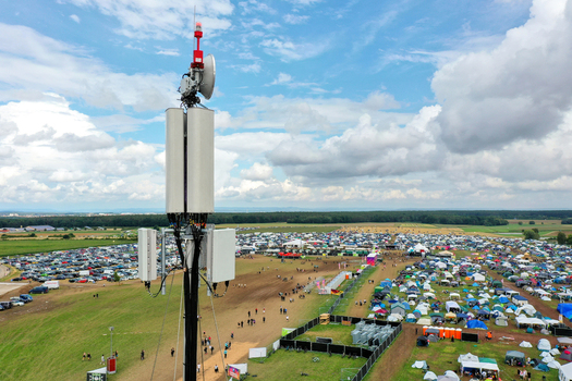 Herzogenaurach Germany 27 July 2025 Aerial view of Open Beatz Festival grounds with a telecommunications tower in the foreground and a vast campsite under a cloudy sky. Herzogenaurach Germany 27 July 2025 Aerial view of Open Beatz Festival grounds with a telecommunications tower in the foreground and a vast campsite under a cloudy sky.