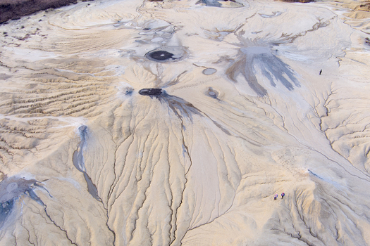 Aerial view of the Mud Volcanoes of Paclele Mari featuring unique mud craters and dry channels in the arid landscape of Paclele Buzau County Romania.