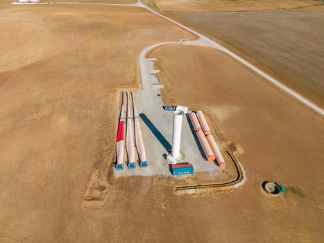 Aerial view of wind turbine blades and tower sections laid out on a construction site in an arid field Swellendam Western Cape South Africa. Aerial view of wind turbine blades and tower sections laid out on a construction site in an arid field Swellendam Western Cape South Africa.