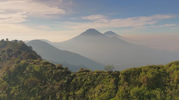 Aerial view of Dieng mountains and misty ridges Indonesia.