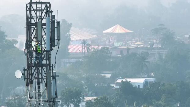 Aerial view of a technician on a telecom tower in Rajshahi Bangladesh.