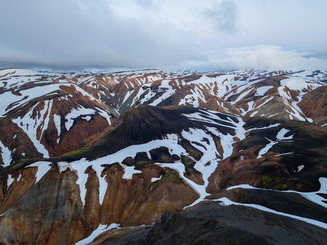 Aerial view of the colorful rhyolite mountains and snow covered volcanic landscape of Landmannalaugar in the highlands of Rangarthing ytra Iceland. Aerial view of the colorful rhyolite mountains and snow covered volcanic landscape of Landmannalaugar in the highlands of Rangarthing ytra Iceland.
