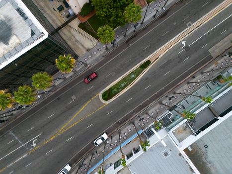 Aerial view of the Hollywood Walk of Fame with its iconic star studded sidewalks palm trees and road traffic in Los Angeles California United States.
