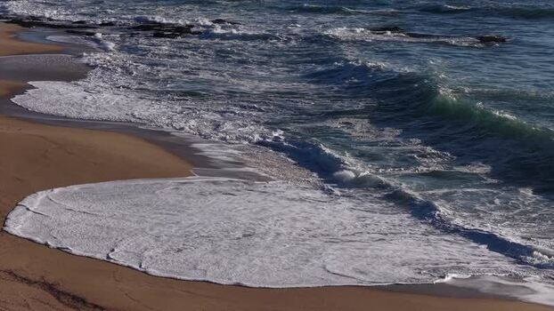 Aerial view of beach with waves Portugal.