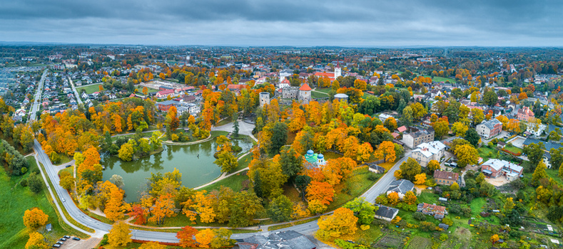 Aerial view of Cesis Castle park surrounded by vibrant autumn foliage historic stone towers and urban rooftops under a cloudy sky in Cesis Cesis Municipality Latvia. Aerial view of Cesis Castle park surrounded by vibrant autumn foliage historic stone towers and urban rooftops under a cloudy sky in Cesis Cesis Municipality Latvia.